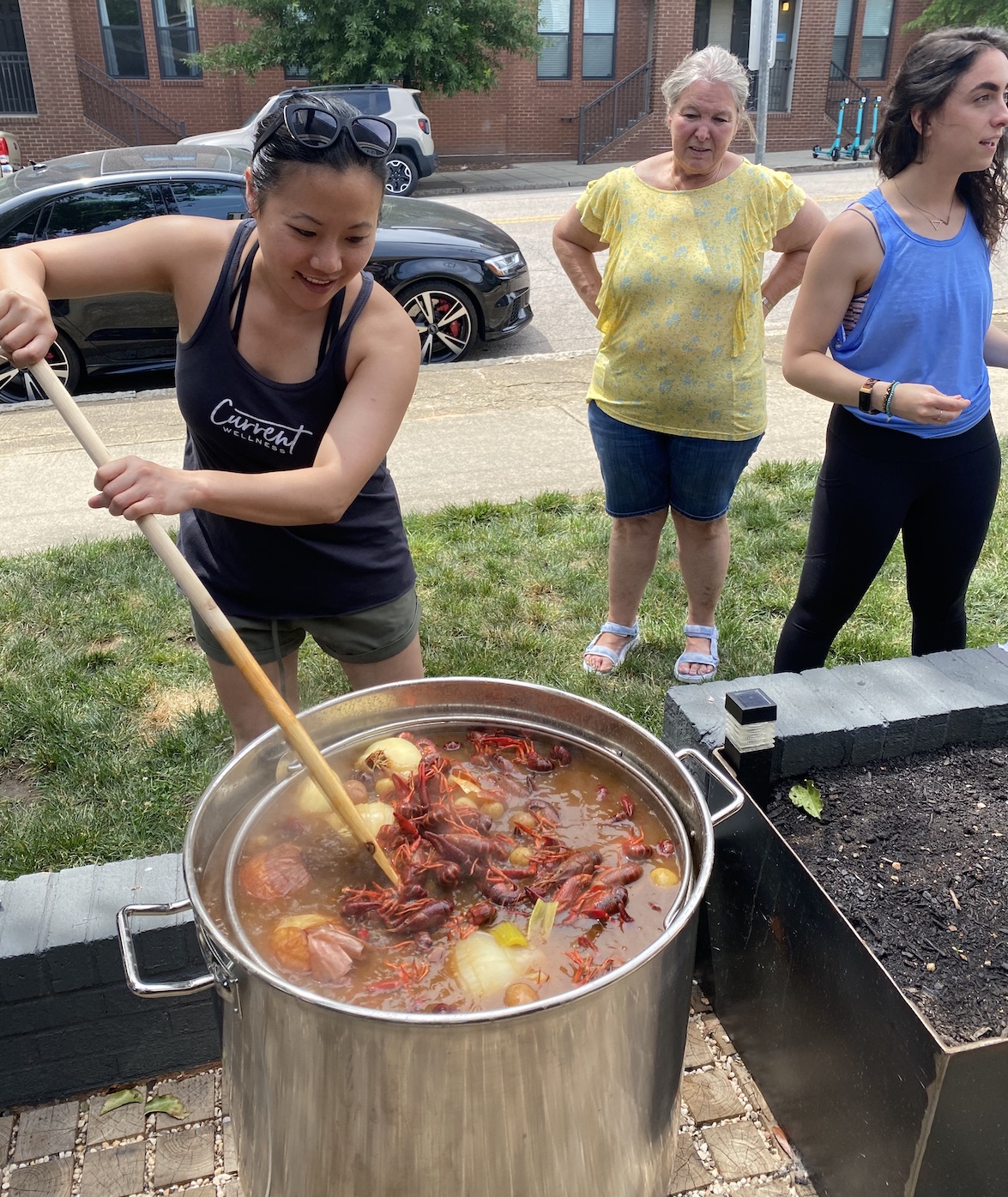 Joyu stirring the pot during our May crawfish boil class